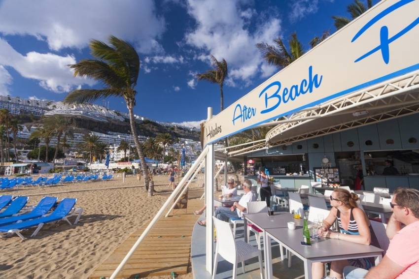 Busy people by Puerto Rico beach in Gran Canaria